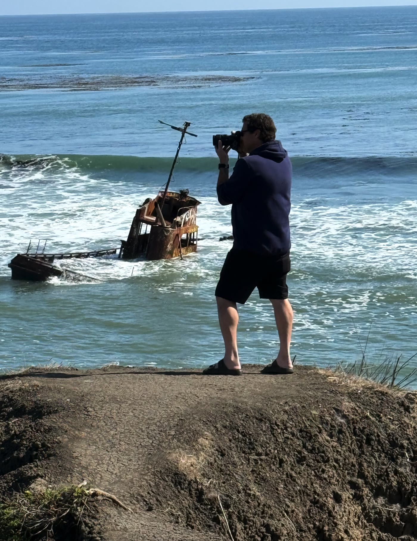 Jason Lawton photographing a shipwreck along the Santa Cruz coastline